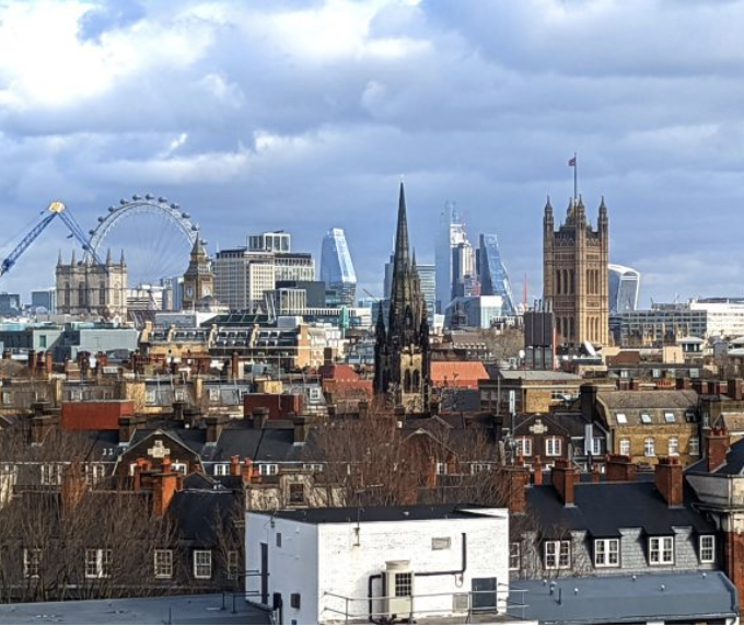 The London skyline in springtime showing the Houses of Parliament and the London Eye